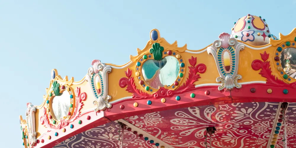 Roof of funfair ride with blue sky