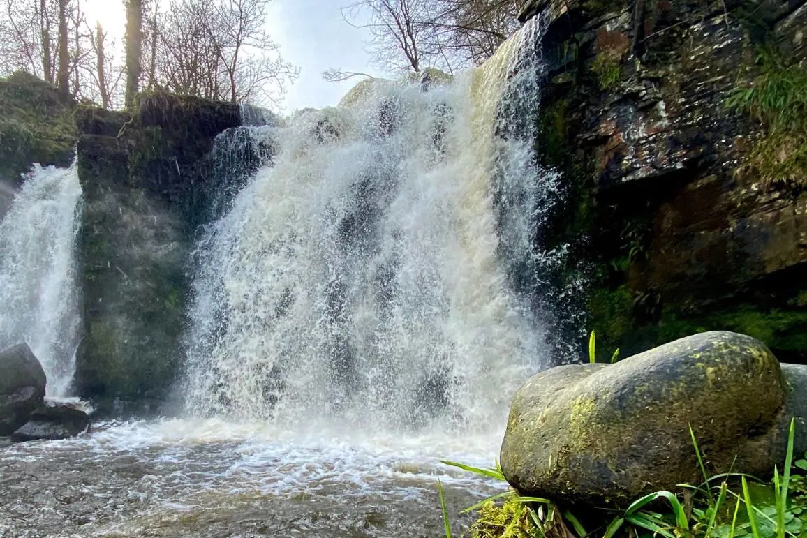 Garnock valley waterfall viewed from the river bank