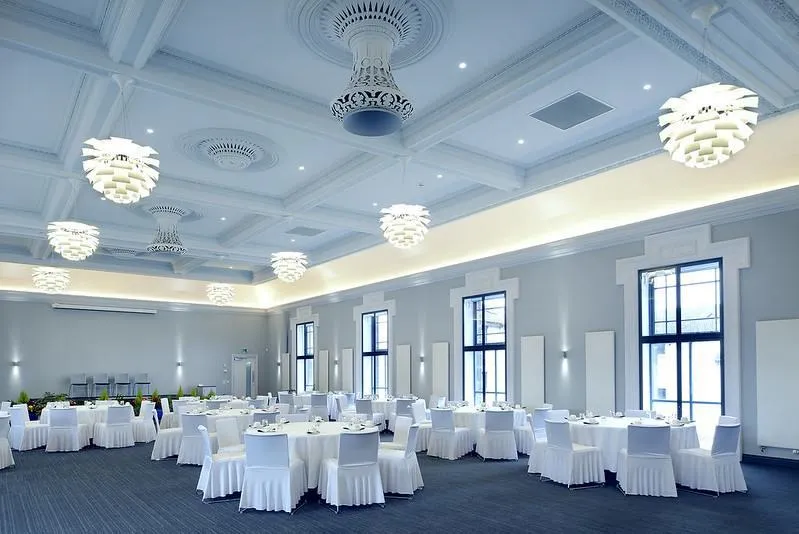 Saltcoats Town Hall venue set up for events with white cloth covered tables and chairs