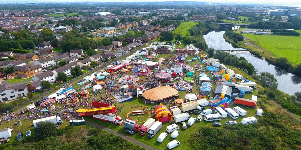 Ariel shot of Irvine moor and Marymass festival featuring tents, people and stalls.