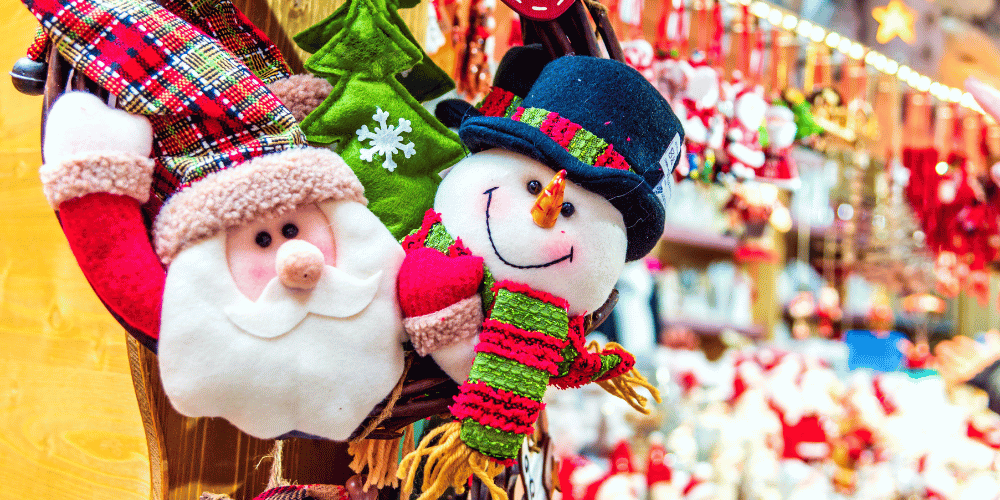 Santa and snowman christmas decoration with market stall in background