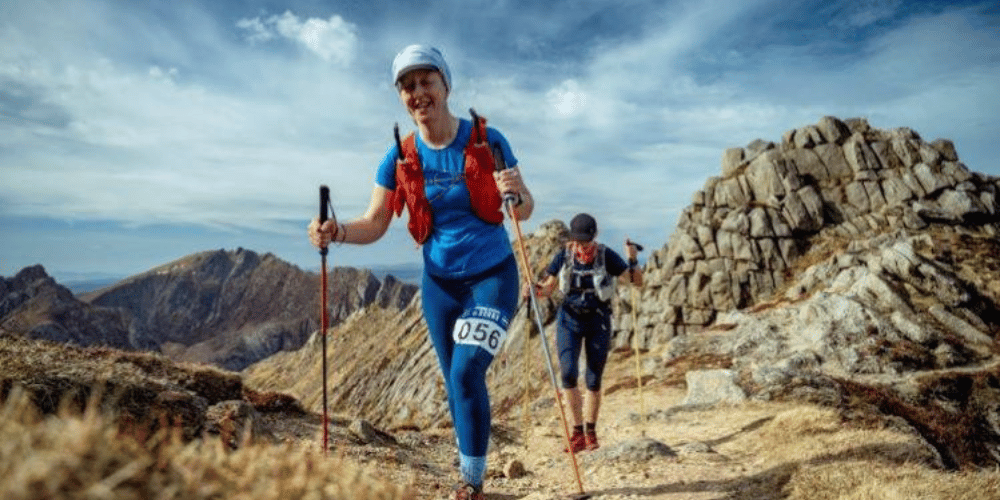 Two women hiking through mountains