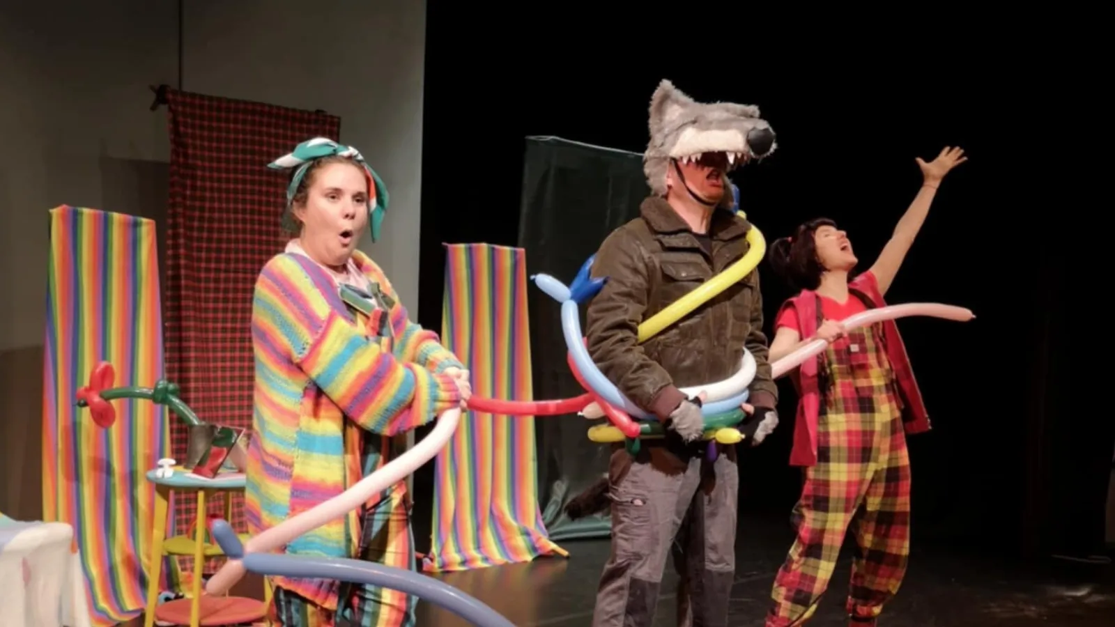 Children's entertainers on stage with balloons and wolf mask